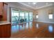 Spacious living room featuring hardwood floors, recessed lighting, ceiling fan, and sliding doors to the patio at 2246 Sifield Greens Way # 36, Sun City Center, FL 33573