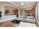 Bright living space with wood floors, view to kitchen and office, and a sliding glass door at 2246 Sifield Greens Way # 36, Sun City Center, FL 33573