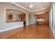 Spacious living room featuring wood floors, an open floor plan, and natural light at 2246 Sifield Greens Way # 36, Sun City Center, FL 33573