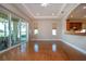 Bright living room featuring hardwood floors, recessed lighting, and sliding doors to the patio at 2246 Sifield Greens Way # 36, Sun City Center, FL 33573