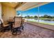 Enjoy tranquil water views from this brick-paved screened patio with comfortable outdoor seating at 2246 Sifield Greens Way # 36, Sun City Center, FL 33573