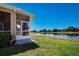 Tranquil backyard view with screened patio, offering a peaceful retreat with serene water views at 2246 Sifield Greens Way # 36, Sun City Center, FL 33573
