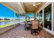 Relax on the screened patio with a ceiling fan, brick flooring and beautiful lake and golf course views at 2246 Sifield Greens Way # 36, Sun City Center, FL 33573