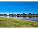 Scenic water view with lush green lawn, creating a serene and picturesque landscape at 2246 Sifield Greens Way # 36, Sun City Center, FL 33573