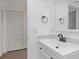 This bathroom offers a white vanity sink, black fixtures and a linen closet at 2650 Countryside Blvd # A104, Clearwater, FL 33761