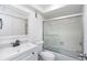 A full bathroom features a shower-tub combo, black fixtures, and a white vanity sink at 2650 Countryside Blvd # A104, Clearwater, FL 33761