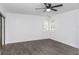 Bright bedroom featuring two shuttered windows, modern flooring, and a ceiling fan at 2650 Countryside Blvd # A104, Clearwater, FL 33761