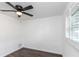 A bedroom featuring a ceiling fan, light walls and wood-look floors at 2650 Countryside Blvd # A104, Clearwater, FL 33761