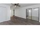 Bright bedroom featuring modern flooring, ceiling fan, closet, and a hallway view at 2650 Countryside Blvd # A104, Clearwater, FL 33761
