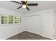 The bedroom features a ceiling fan, wood-look floors and a closet with double doors at 2650 Countryside Blvd # A104, Clearwater, FL 33761