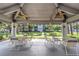 Community gazebo with ceiling fans providing a view of the pond and surrounding landscaping at 2650 Countryside Blvd # A104, Clearwater, FL 33761