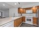 Kitchen with laminate countertops, wood cabinets and stainless steel appliances at 2650 Countryside Blvd # A104, Clearwater, FL 33761