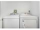 A laundry room featuring a white Whirlpool washer and dryer set at 2650 Countryside Blvd # A104, Clearwater, FL 33761