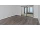 Bedroom features wood-look vinyl flooring and sliding glass doors at 2650 Countryside Blvd # A104, Clearwater, FL 33761