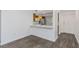 Open-plan living area with wood-look floors leading into the kitchen at 2650 Countryside Blvd # A104, Clearwater, FL 33761