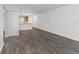 Bright and airy living room with wood-look vinyl floors and adjacent kitchen at 2650 Countryside Blvd # A104, Clearwater, FL 33761