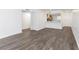 Open living room features modern flooring, fresh paint, and an open view to the kitchen at 2650 Countryside Blvd # A104, Clearwater, FL 33761