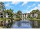 Beautiful community pond view with fountain and lush landscaping surrounding buildings at 2650 Countryside Blvd # A104, Clearwater, FL 33761