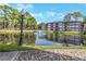 Beautiful community view with a fountain in the pond and lush landscaping at 2650 Countryside Blvd # A104, Clearwater, FL 33761