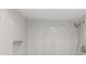 Modern shower features tiled wall with a built-in shelf and a rainfall shower head at 2650 Countryside Blvd # A104, Clearwater, FL 33761