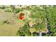 An aerial view of the property, highlighting its location amidst green space and established trees at 27477 Old Trilby Rd, Brooksville, FL 34602