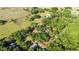 An aerial view shows the property lines and surrounding landscape with lush greenery and mature trees at 27477 Old Trilby Rd, Brooksville, FL 34602