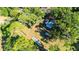 An aerial view showing a cozy cottage nestled amid trees, offering privacy and seclusion at 27477 Old Trilby Rd, Brooksville, FL 34602
