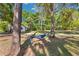 Serene backyard featuring a relaxing hammock strung between trees, creating a peaceful outdoor retreat at 27477 Old Trilby Rd, Brooksville, FL 34602