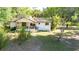 A charming single-Gathering home with a covered porch and lush surrounding greenery at 27477 Old Trilby Rd, Brooksville, FL 34602