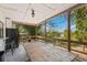 Covered patio with wooden table and chairs, offering serene outdoor views and a relaxing ambiance at 27477 Old Trilby Rd, Brooksville, FL 34602
