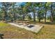 Picnic area on the property featuring multiple tables, grill and mature trees for outdoor entertainment at 27477 Old Trilby Rd, Brooksville, FL 34602