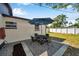 Quaint backyard patio featuring outdoor dining set and garden at 2873 Karen Ave, Largo, FL 33774