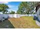 Fenced backyard featuring a storage shed, seating, grass, and partial views of the home's exterior at 2873 Karen Ave, Largo, FL 33774