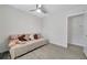 Bedroom featuring a daybed, plush pillows, and tile floors, with a view into the hallway for easy access at 2873 Karen Ave, Largo, FL 33774