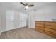 This bedroom has wood-look tile, a ceiling fan, and closet space at 2873 Karen Ave, Largo, FL 33774