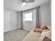 Bright bedroom with a teddy bear on the daybed, tile floors, curtains, and a ceiling fan to make it relaxing at 2873 Karen Ave, Largo, FL 33774