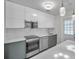 Modern kitchen features sleek cabinetry, stainless steel appliances, and a stylish quartz countertop at 2873 Karen Ave, Largo, FL 33774