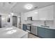 Modern kitchen with stainless steel appliances, sleek cabinetry, and an island, open to living area at 2873 Karen Ave, Largo, FL 33774