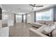Bright living room with tile floors, ceiling fan, and large windows offering natural light and a comfortable sectional sofa at 2873 Karen Ave, Largo, FL 33774