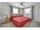Charming bedroom with wood nightstands, two windows, tile floors and a ceiling fan with light for a comfortable retreat at 2873 Karen Ave, Largo, FL 33774