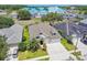 Aerial view of home with manicured front lawn, two-car garage, and mature landscaping in a desirable neighborhood at 2919 Northfield Dr, Tarpon Springs, FL 34688