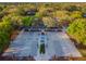 Aerial view of a community basketball court with multiple hoops, shaded seating, and surrounding green spaces at 2919 Northfield Dr, Tarpon Springs, FL 34688
