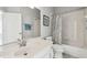Bathroom featuring single sink with quartz countertops, white cabinetry, and tub shower at 2919 Northfield Dr, Tarpon Springs, FL 34688