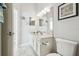 Bathroom features a single sink with white cabinets and decorative elements for a coastal vibe at 2919 Northfield Dr, Tarpon Springs, FL 34688