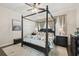 Primary bedroom features a four-poster bed, ceiling fan, and decorative touches for a comfortable retreat at 2919 Northfield Dr, Tarpon Springs, FL 34688