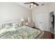 Well-lit bedroom with ceiling fan, hardwood floors, white furniture, and closet doors at 2919 Northfield Dr, Tarpon Springs, FL 34688