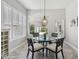 Cozy breakfast nook with a glass-top table and chairs is surrounded by natural light from large windows at 2919 Northfield Dr, Tarpon Springs, FL 34688