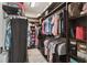 Walk-in closet featuring custom shelves, rods, and ample storage space at 2919 Northfield Dr, Tarpon Springs, FL 34688