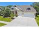 Beautiful home featuring lush landscaping, two car garage, and a welcoming facade at 2919 Northfield Dr, Tarpon Springs, FL 34688