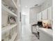 Hallway with white cabinets, desk, and shelves and neutral walls for a clean and modern look at 2919 Northfield Dr, Tarpon Springs, FL 34688